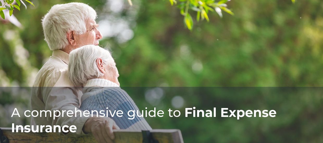 Elderly couple sitting closely on a bench in a serene garden setting.