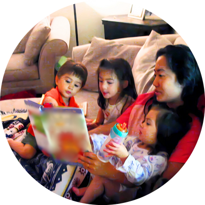 Author reading a book to three young children