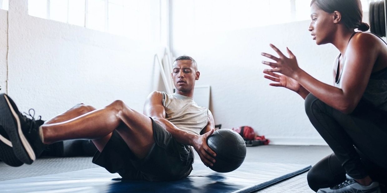 Personal trainer working with a client