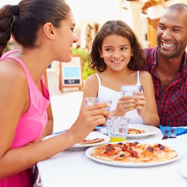 family vacationing in Umbria enjoying a delicious pizza