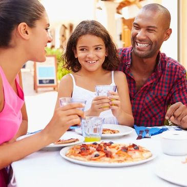 Family enjoying pizaz in Italy