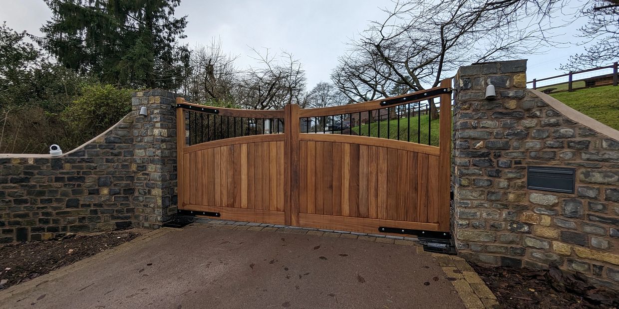 wooden automated gate with underground bft motors, lights and cctv