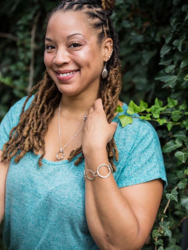 Model wearing Argentium silver earrings, Argentium silver bracelet, and Argentium silver necklace 