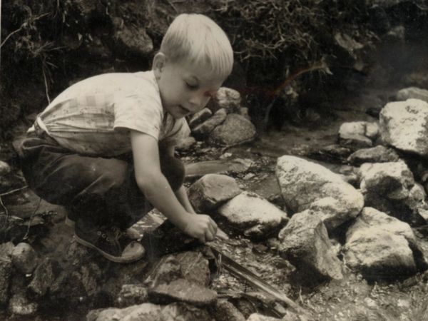 Missionary kid (MK) plays in the stream behind the school