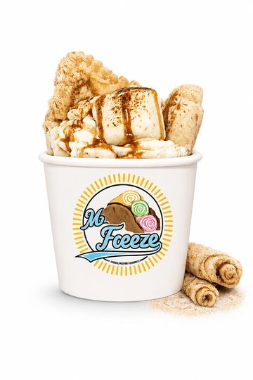 Cup of dessert with marshmallows, wafer rolls, and caramel drizzle.