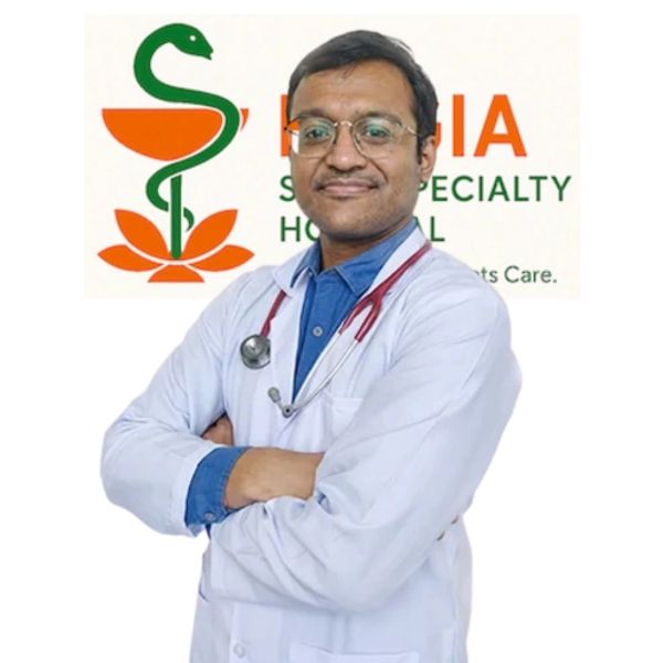 Confident doctor with stethoscope standing in front of hospital logo.