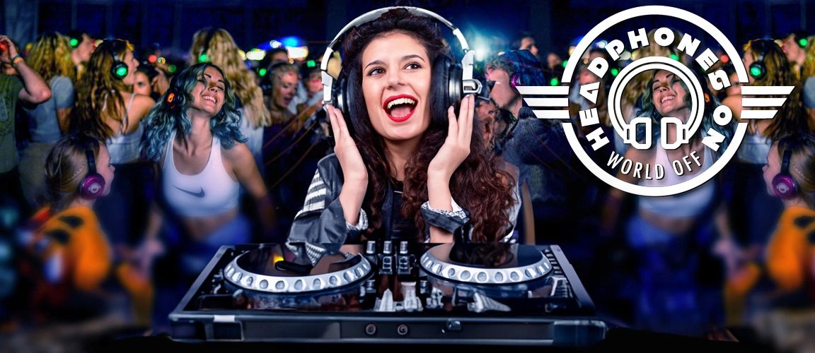 A lively DJ wearing headphones entertains a crowd at a silent disco party.