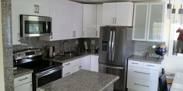 Modern kitchen with granite countertops and stainless steel appliances.