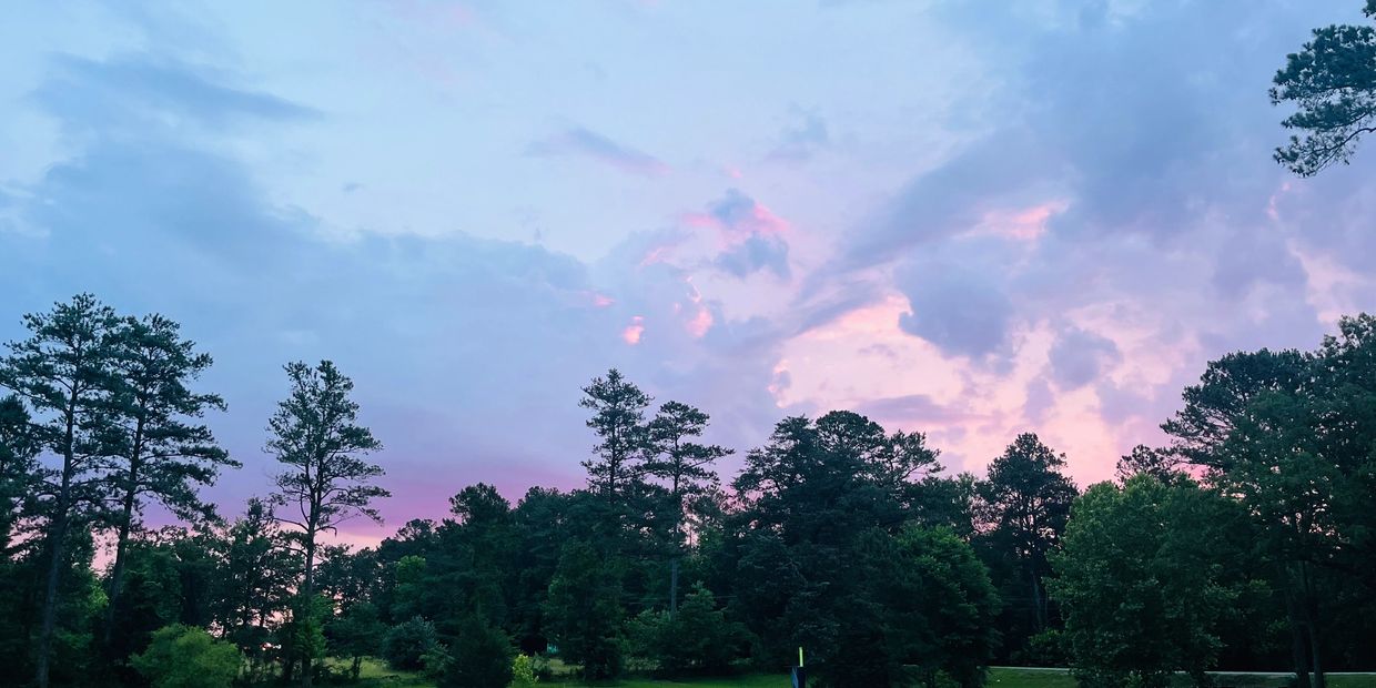 Serene sunset over the lake at Scenic City campground, surrounded by tranquil natural beauty.