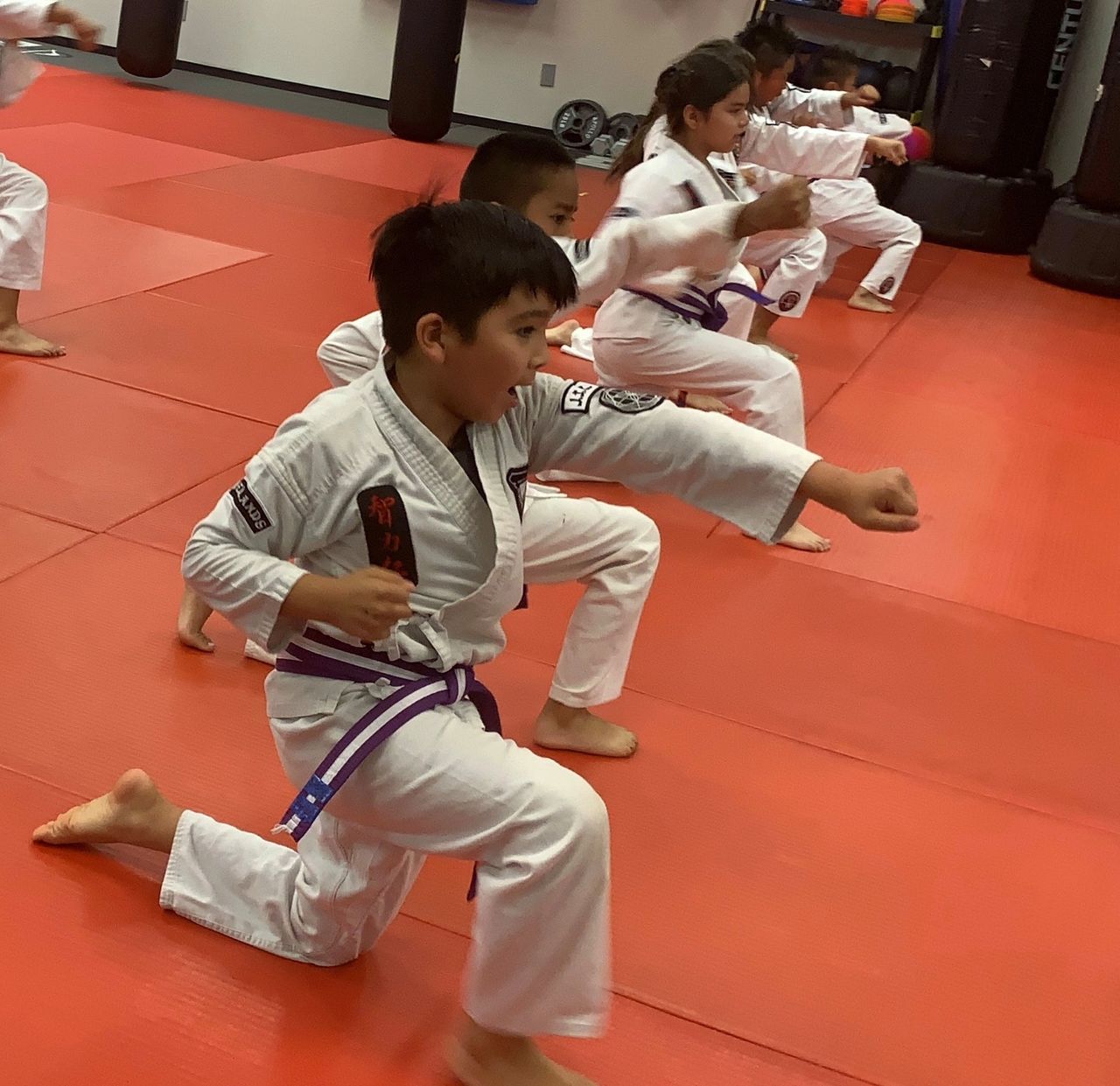 https://img1.wsimg.com/isteam/ip/065869b5-3424-4358-8afe-83be8c1c90d4/Kneeling%20kids%20punching.jpg/:/cr=t:0%25,l:0%25,w:100%25,h:100%25/rs=w:1280