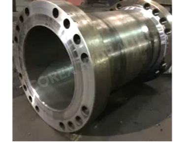 Large metallic cylindrical industrial component with flanged ends and bolt holes.