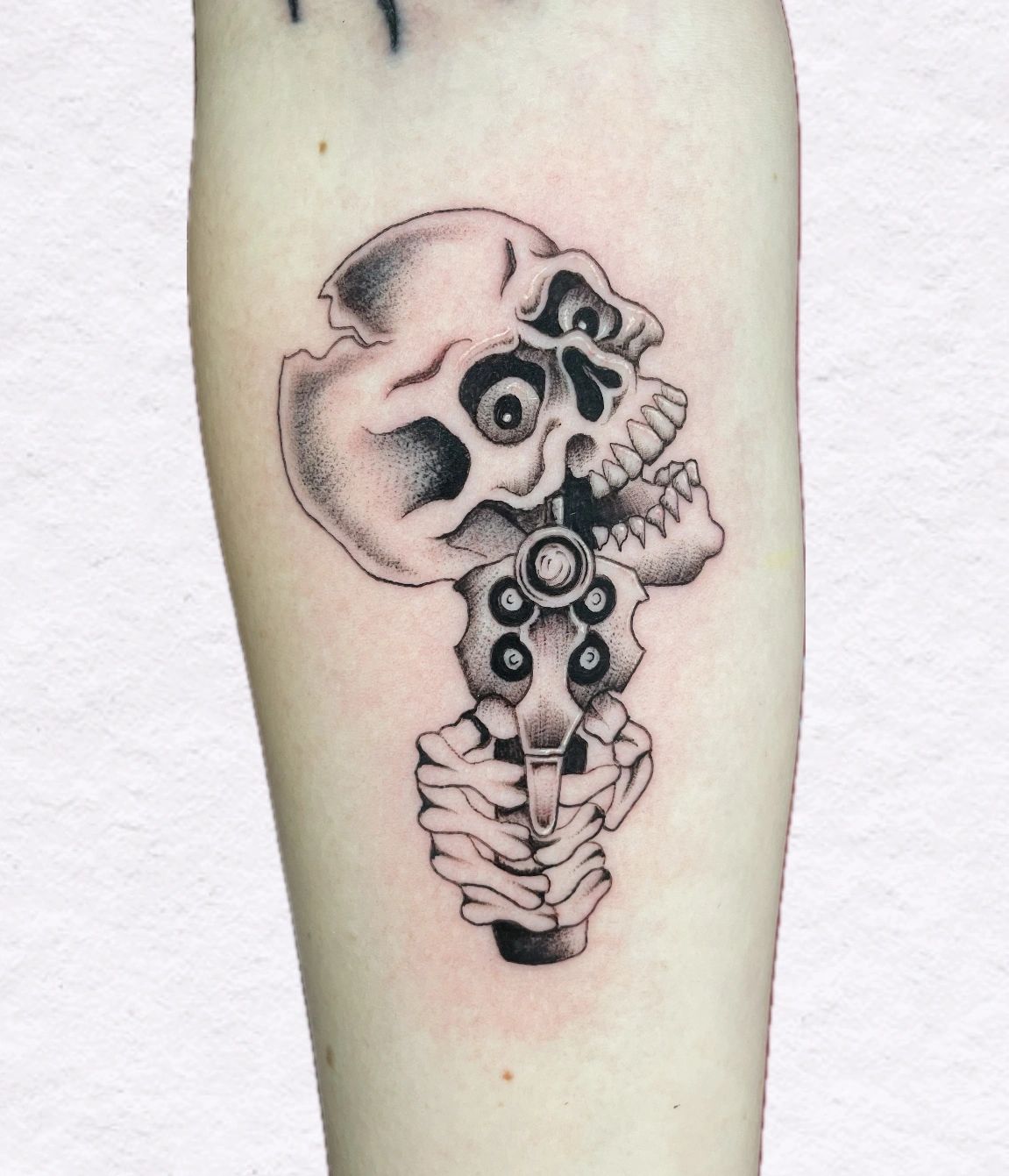 Skull and Revolver Fine line Tattoo