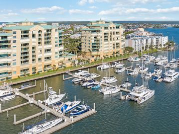 Marina with boats docked near waterfront apartment buildings.