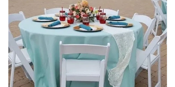 Tiffany tablecloth, white lace runner, teal napkins, with gold charger plates. 