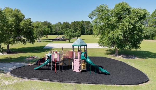 Aerial view of playground with rubber mulch highlighting safety and style.