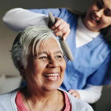 Caregiver assisting senior woman with daily living tasks