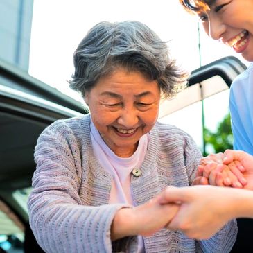 Caregiver assisting a senior woman with transportation
