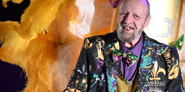 Man in colorful Mardi Gras costume.