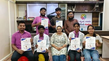 Group of students and instructors holding certificates at Bright Minds Academy.