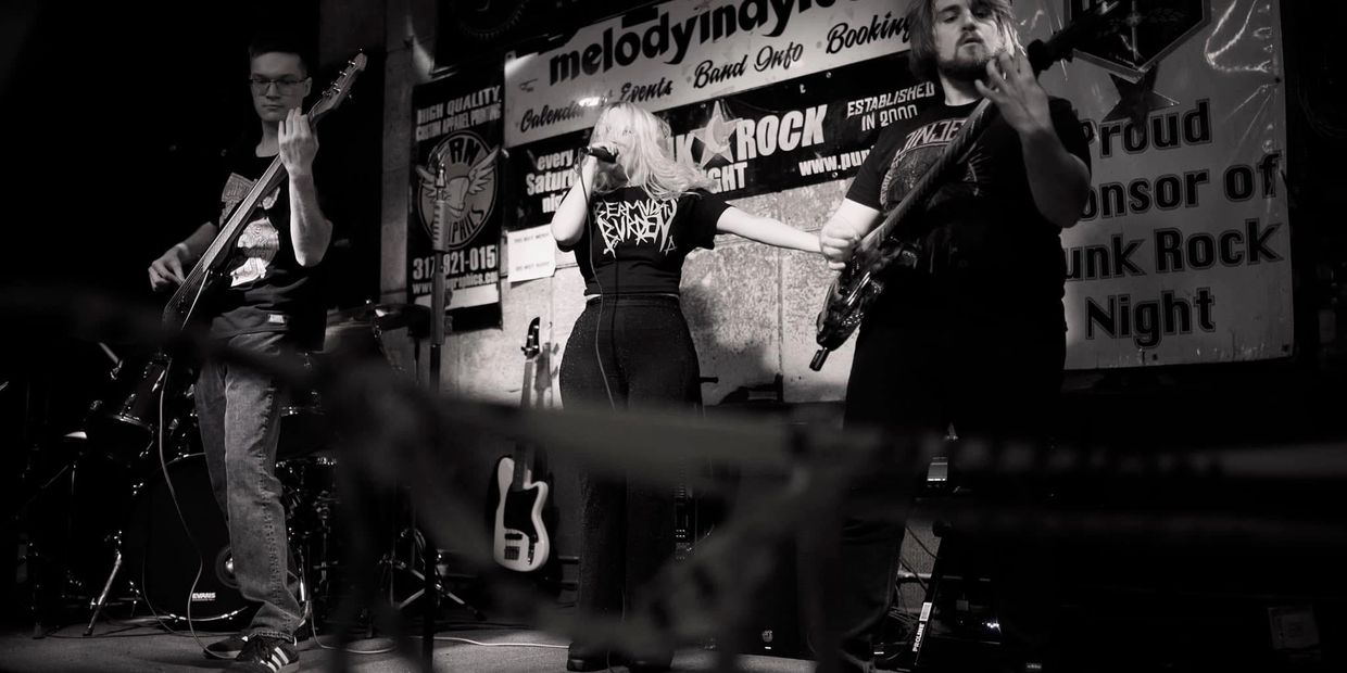 Heavy metal band Bermuda's Burden performing in a venue.