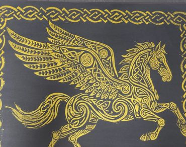 Intricate golden Pegasus design with Celtic knot patterns on a dark background.