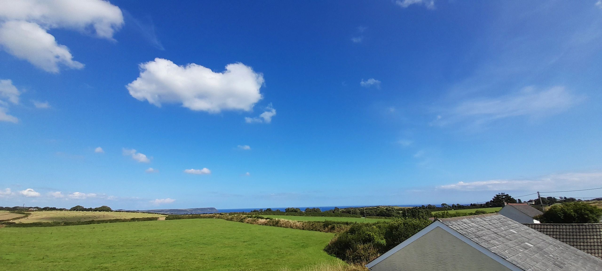 The view east to Dodman Head in the far distance across Veryan Bay, from our home.