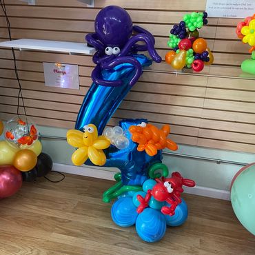 Colorful balloon sculptures of sea creatures including an octopus and fish.