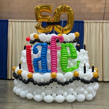 A colorful balloon sculpture with the number 50 in gold balloons.