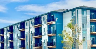 Modern apartment building with blue sky.