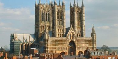 Historic cathedral with gothic architecture under a blue sky.