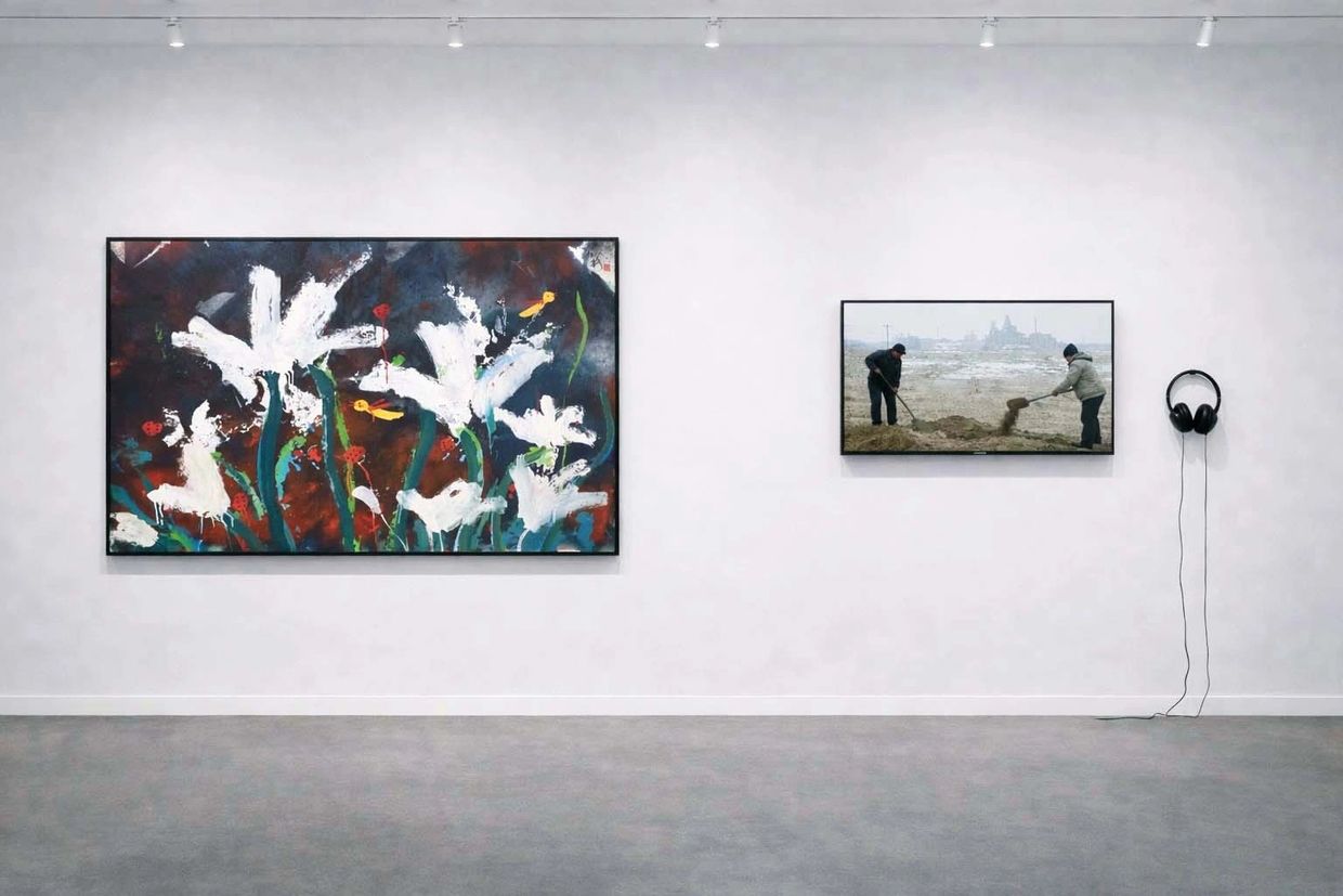 Art gallery wall with two paintings and headphones for audio.