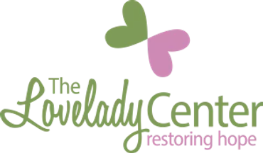 Logo of The Lovelady Center with green and pink heart shapes.