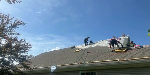 Roofers installing new roof shingles in a home in Pennsylvania.
