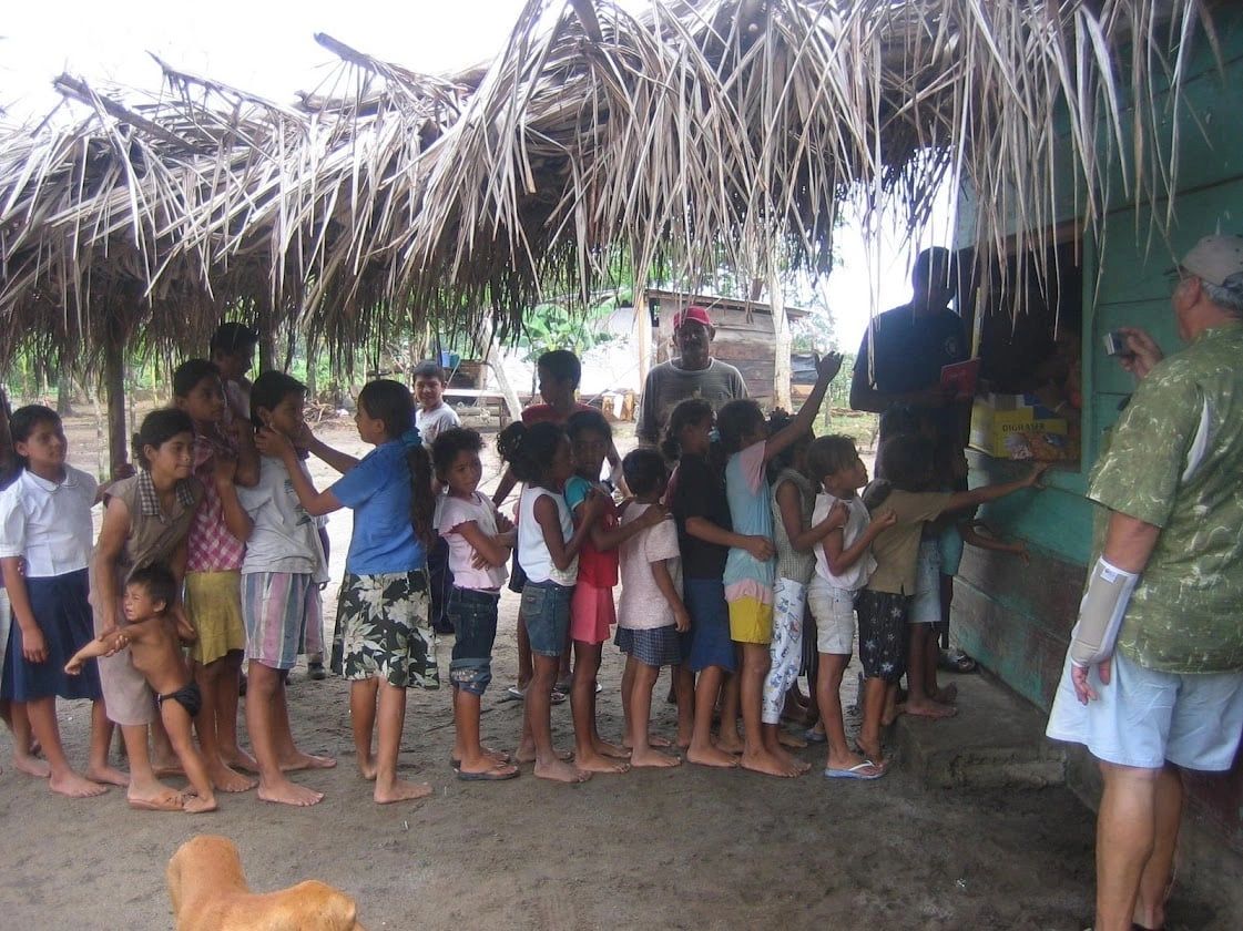 Children lined up during a school supply visit connected to Río Niño river travel