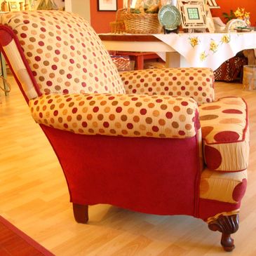 Polka dot patterned armchair with red sides in a cozy room.