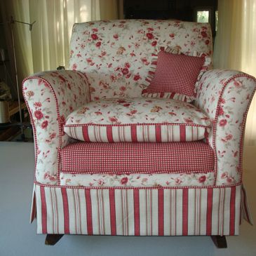 Floral and striped upholstered armchair with a matching cushion.