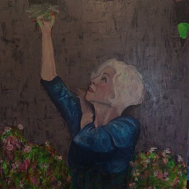 Woman with white hair reaching upward with flowers.