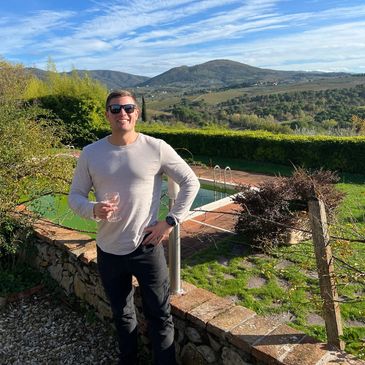 Me standing on an Italian hill on a Trafalgar tour, showcasing Italy's scenic beauty. Insight 