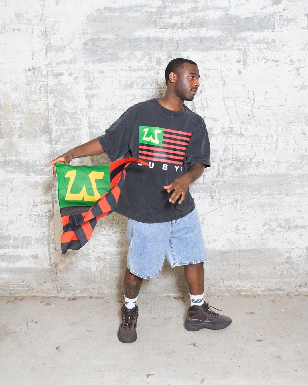 Man holding a flag with urban style.