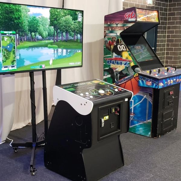 A Golden Tee and NFL Blitz arcade