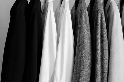 A row of black, white, and gray jackets hanging neatly.