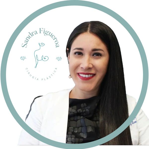 Portrait of a smiling woman in a white coat with a plastic surgery logo.