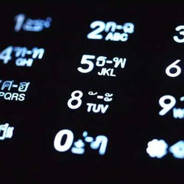 Phone keypad with numbers and Thai characters.