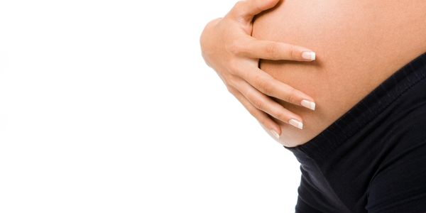 Pregnant woman's stomach with hand support