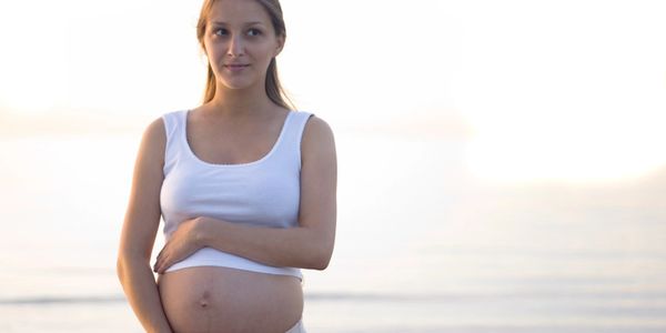 Tranquil image of a pregnant woman cradling their bump.