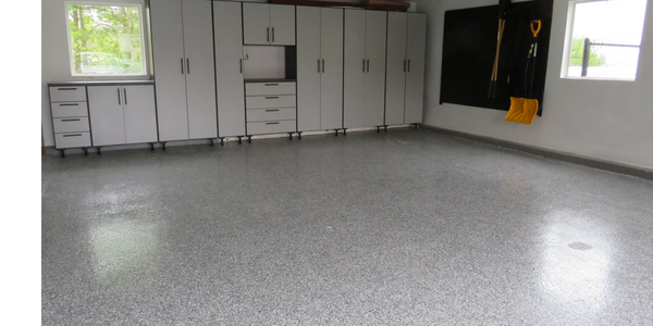 Standing garage cabinet storage system with slatwall panels and brand new epoxy floor coating .