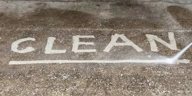 Pressure washing reveals the word CLEAN on a dirty surface.