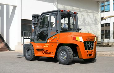 Orange Vinca forklift parked outside a building.