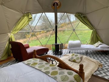 Glamping in west wales, geodesic dome sleeps 6 log burner, dining table, kitchen and alfresco bath