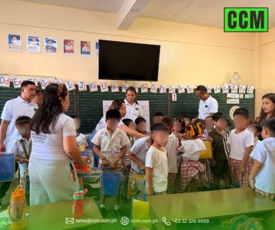 Teachers and students engaged in a classroom activity with learning materials.